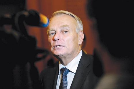 French Prime minister Jean-Marc Ayrault answers journalists' questions after casting his ballot...