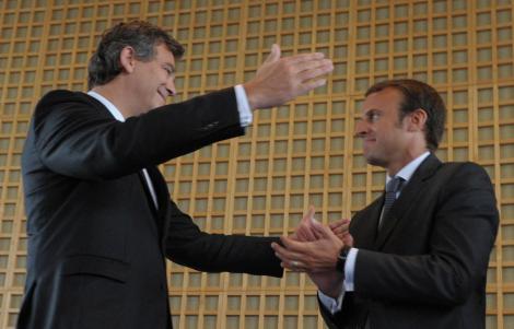 Outgoing French Economy Minister Arnaud Montebourg (L) congratulates on August 27, 2014 with his...